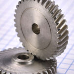 2 identical steel helical gears with small hub on one face