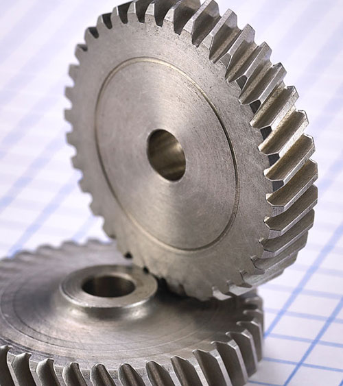 2 identical steel helical gears with small hub on one face